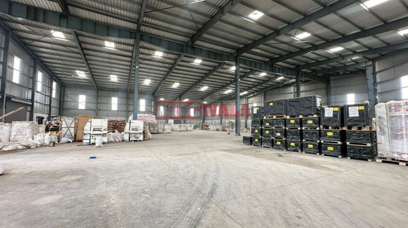 A spacious industrial warehouse with high ceilings and ample natural light, perfect for manufacturing and storage needs.