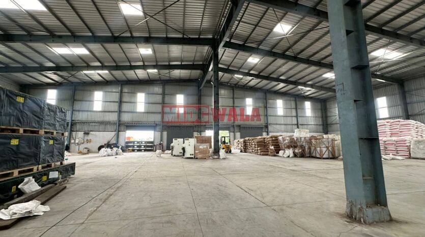 A spacious industrial warehouse with high ceilings and ample natural light, perfect for manufacturing and storage needs.