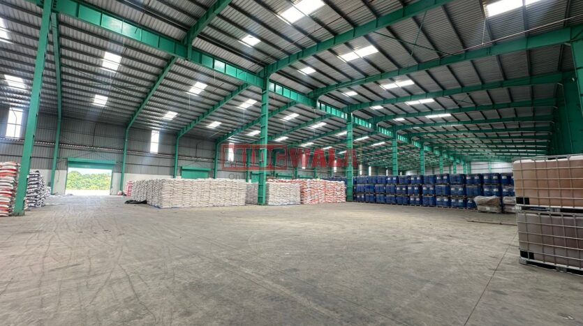 A spacious warehouse space with high ceilings and ample natural light, perfect for your business needs.