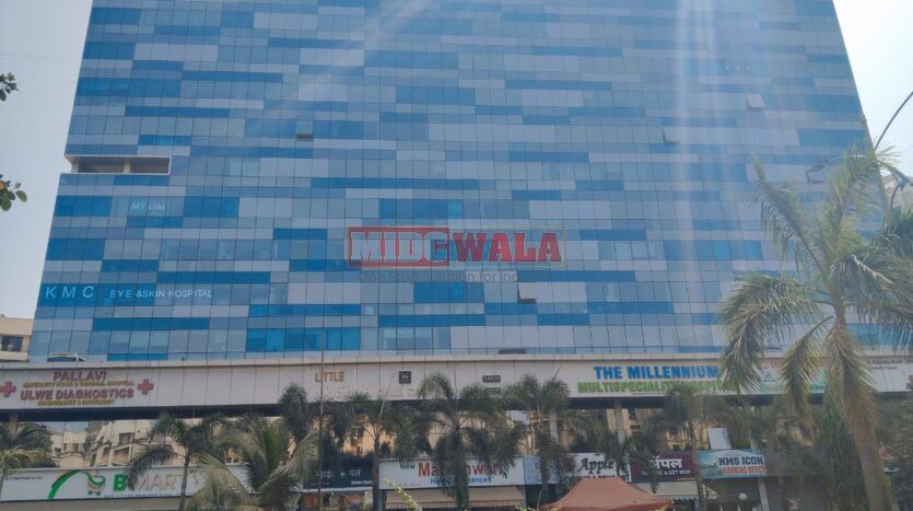 A modern, glass-fronted office building in Ulwe, India, with a sign advertising "Ready-to-move-in office space for sale