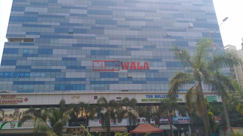 A modern, glass-fronted office building in Ulwe, India, with a sign advertising "Ready-to-move-in office space for sale